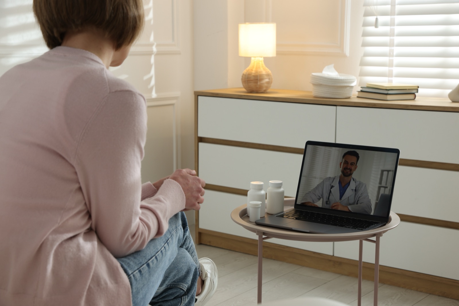 A patient in a virtual consultation with a clinician from home